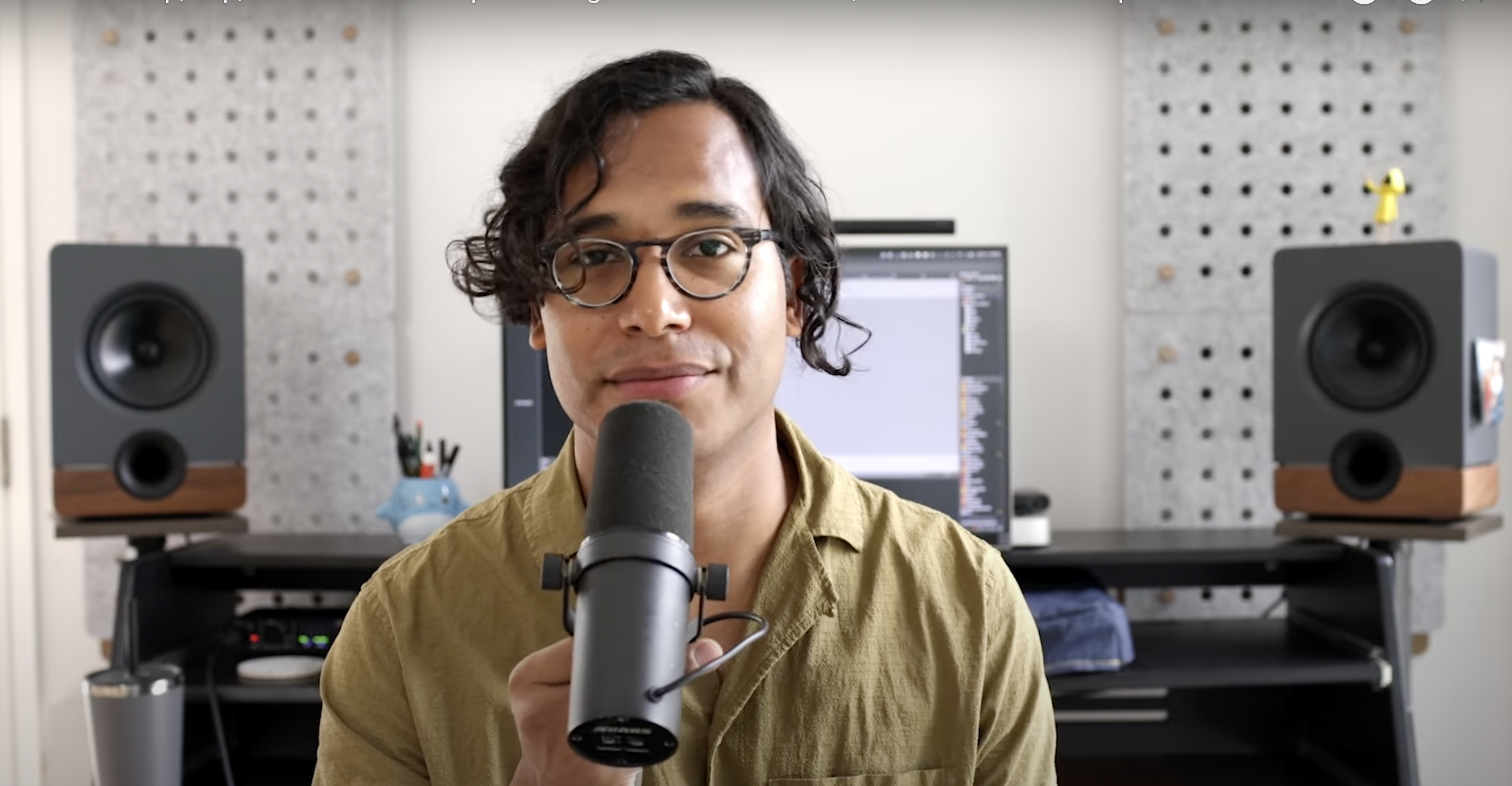 Onesto at desk with microphone